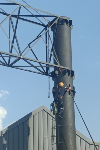 PJR Engineering project team assembling a fabricated steel billboard support structure at height