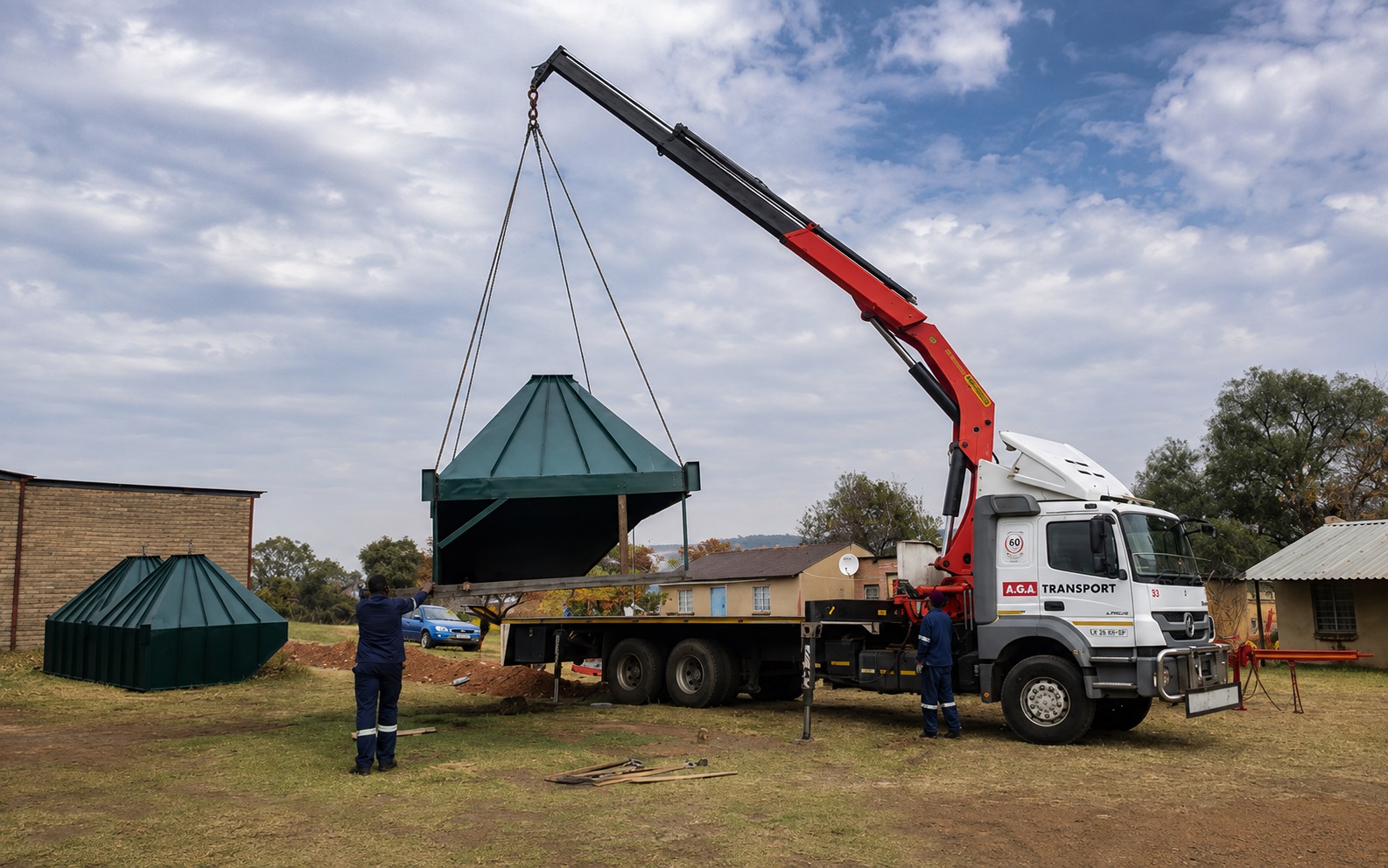 A crane truck positions a fabricated plant hopper during a PJR Engineering machinery installation project.